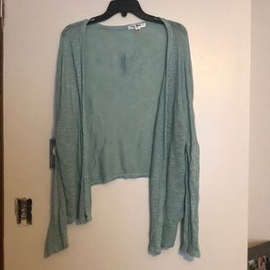 Light blue or teal cardigan